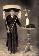 1800's Northern Vietnamese woman dressed in Ao Tu Than, with the "Non Quai Thao" hat characteristic of North Vietnam
